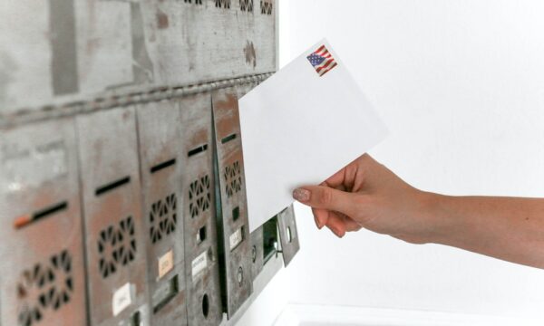 Person Holding White Envelope