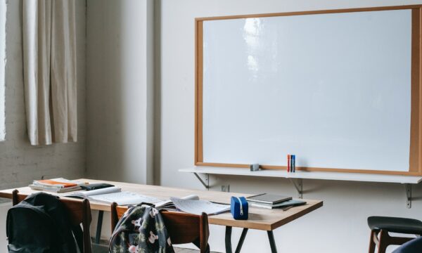 School bench with stationery in classroom