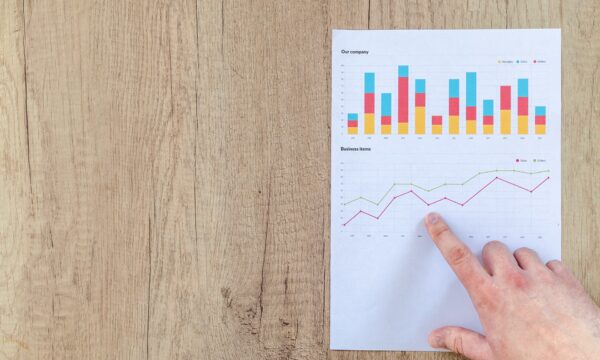 Person Pointing Paper Line Graph