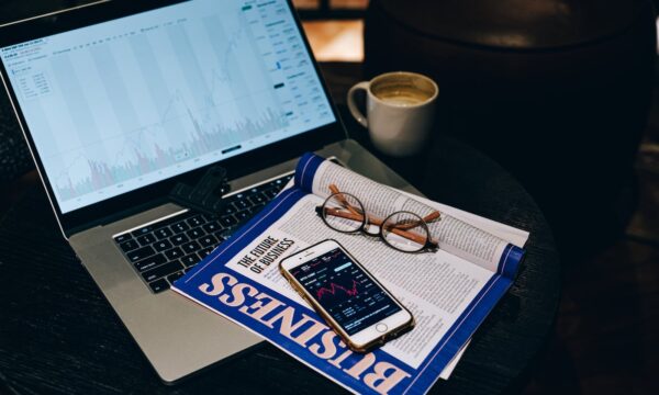 Newsletter with Smartphone and Eyeglasses on Laptop